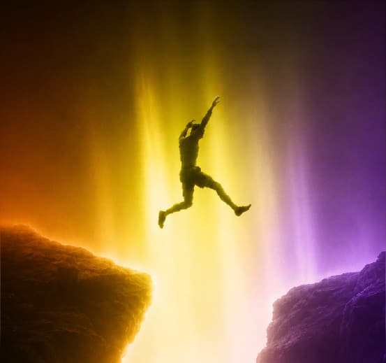 Creator leaping between cliffs, representing access to global brand collaboration opportunities